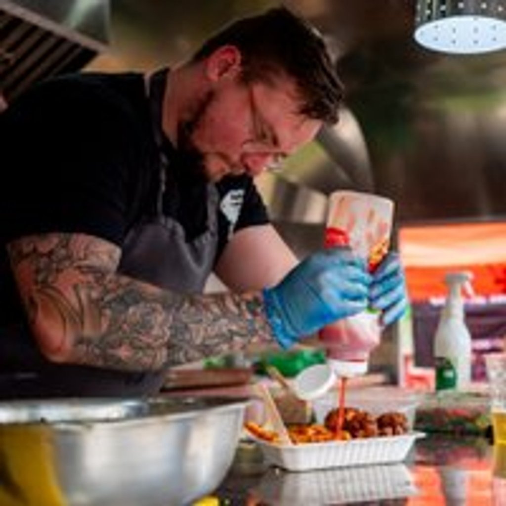 New Street Eats food festival in Birmingham with vibrant stalls and happy visitors.